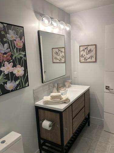 a bathroom with a sink and a mirror at Smashing Newly-Built with Ocean/Bay/City Views! in San Diego