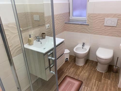 a bathroom with a sink and a toilet at R Home in Ischia
