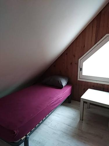 Tempat tidur dalam kamar di Gite d'alexis