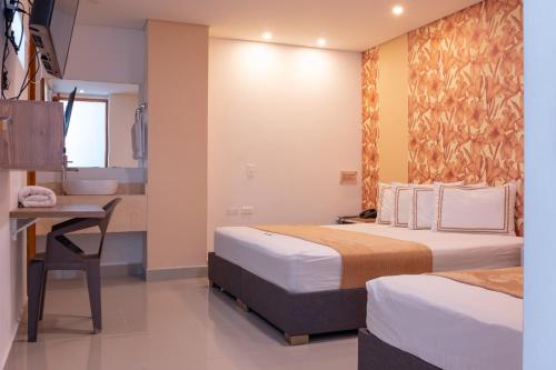Postel nebo postele na pokoji v ubytování Infinity Hotel