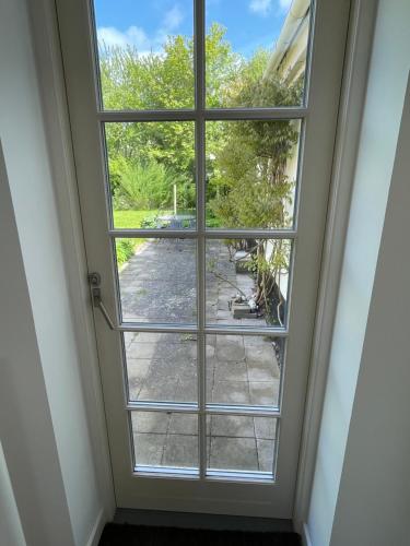 a window with a view of a yard at A true nature pearl in idyllic surroundings but close to the city in Holbæk