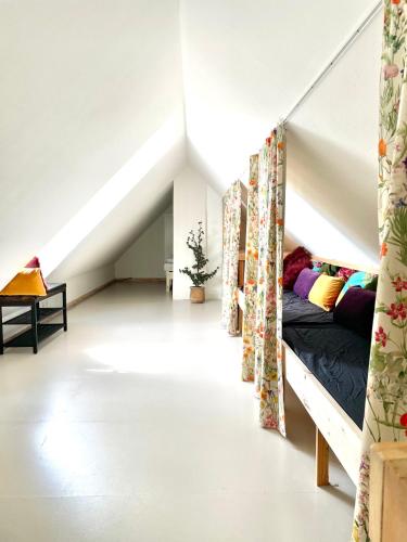 a room with a bunk bed in a attic at A true nature pearl in idyllic surroundings but close to the city in Holbæk