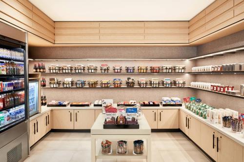 a grocery store aisle with shelves of food at AC Hotel by Marriott Pleasanton in Pleasanton