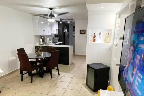 a kitchen and dining room with a table and chairs at Peaceful Luxury Villa - TheShine&GlowPlace in Fajardo