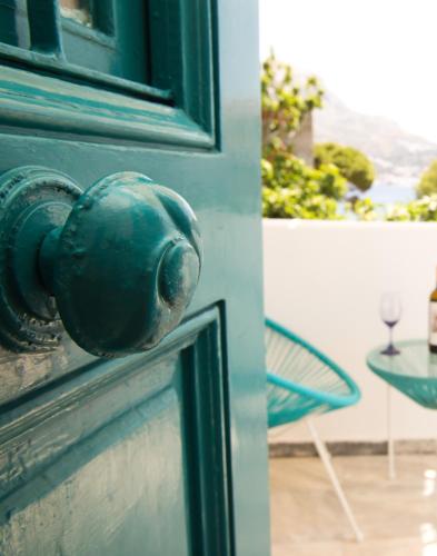 a green door with a knob on a house at SUITES DREAM TELENDOS in Telendos