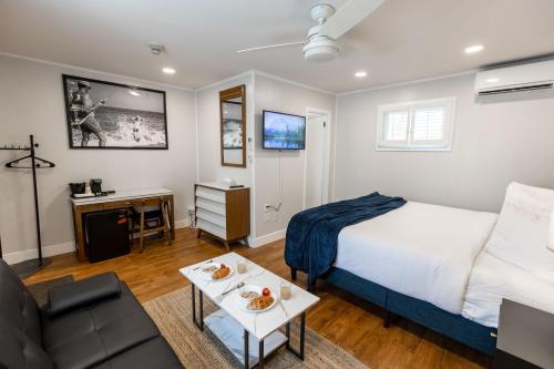 a bedroom with a bed and a couch and a table at Ocean View Terrace in Hampton Bays