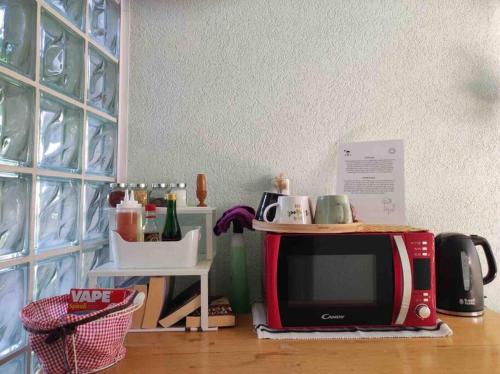 a microwave sitting on top of a wooden floor at Center of town rooms!No.1 in Vis