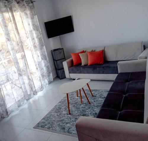 a living room with a couch and a table at Orik Apartament in Vlorë