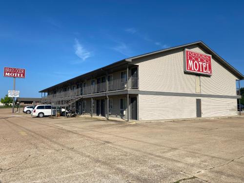 a motel with a sign on the side of a building at Brass Door Motel in Gassville