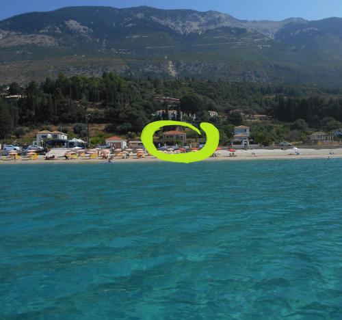a yellow frisbee flying over a beach at Diona Studios in Lourdhata