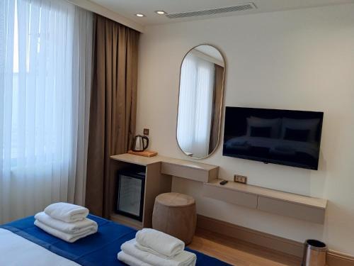 Habitación de hotel con cama y espejo en Taksim Bosphorus Hotel, en Estambul