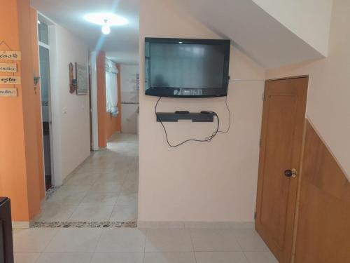 a television on a wall in a hallway at Hermoso Alojamiento in Choachí