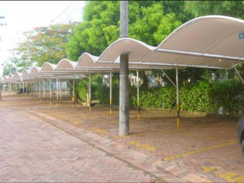 a parking lot with a row of umbrellas at Apartamento Girardot Resort in Girardot