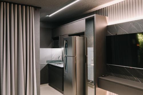 a kitchen with a stainless steel refrigerator in it at Flat Bristol 911 in Goiânia