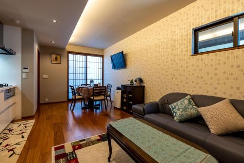 uma sala de estar com um sofá e uma mesa em 京 吉乃家 em Giommachi