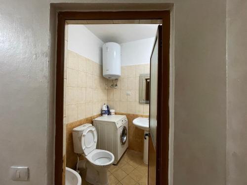 a bathroom with a toilet and a sink at B&B - Private rooms 2 in Tirana