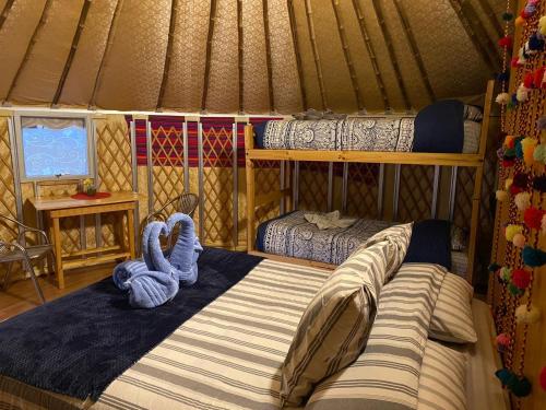a bedroom with two beds in a yurt at Altos de Quitor , Glamping in San Pedro de Atacama