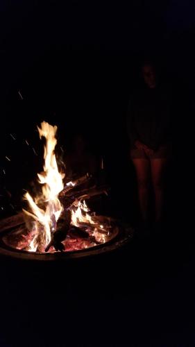 a fire is burning in a grill in the dark at Battenkill Glamping Resort in Cambridge
