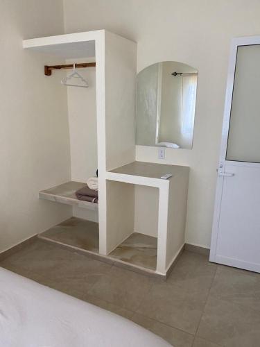 a white bathroom with a sink and a mirror at Los Amores Apartments C in Pérula