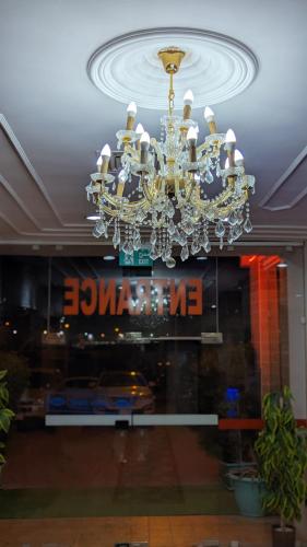 a chandelier hanging from a ceiling in a store at Arinza Tower Quality Apartments in Kuwait