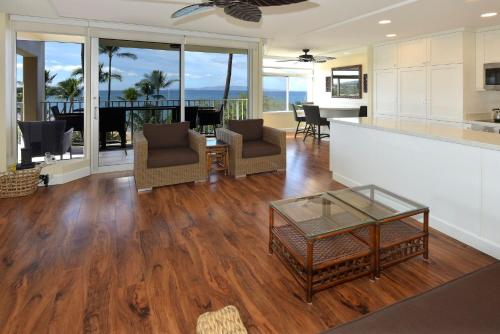 a kitchen and living room with a view of the ocean at The Hale Pau Hana in Kihei
