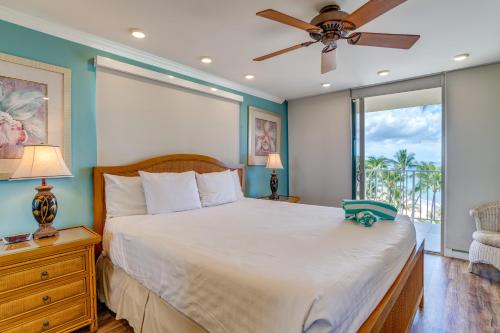 a bedroom with a bed and a ceiling fan at The Hale Pau Hana in Kihei