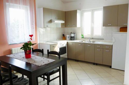 a kitchen with a table and a kitchen with a table and chairs at Apartments with a parking space Krk - 5371 in Krk