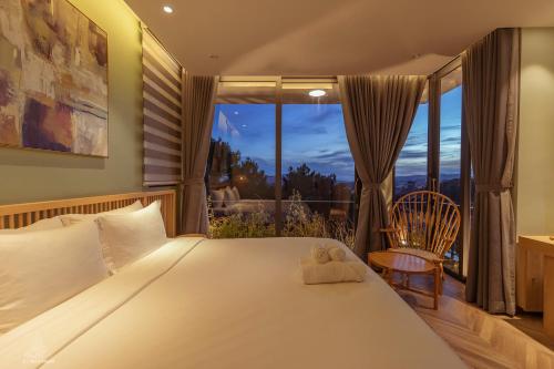 a bedroom with a large bed and a window at La Villa Da Lat in Khu Chi Lăng