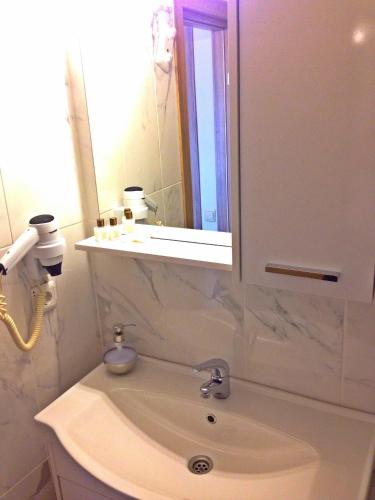 a bathroom with a sink and a mirror at Naz Wooden House Inn in Istanbul