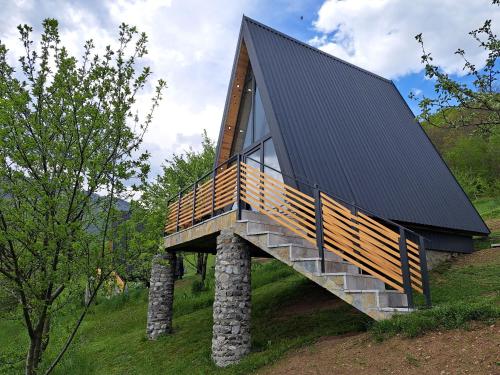 a house with a roof on top of a hill at Fern Farm Tiny Home in Mojkovac