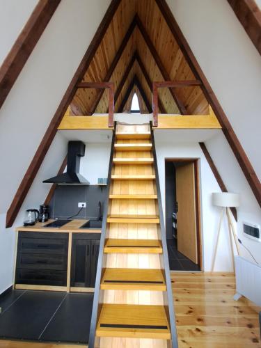 a staircase leading up to a kitchen in a loft at Fern Farm Tiny Home in Mojkovac