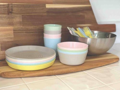 a group of bowls and plates on a cutting board at @wild_olive_den ~ Serene Weekend Getaway Cabin in Running Springs