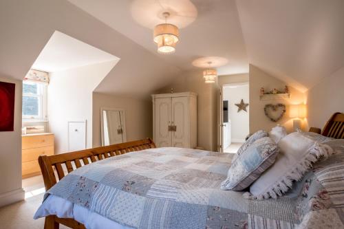 a bedroom with a large bed in a room at Sandy Lodge Rock in Padstow