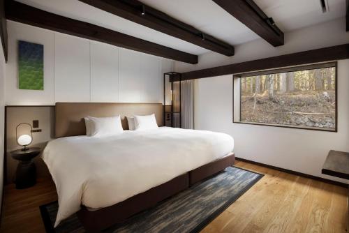 a bedroom with a large bed and a window at SOMA RESIDENCE HAKUBA in Hakuba