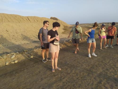 a group of people walking down a dirt road at Ambigua Hospedaje in Trujillo