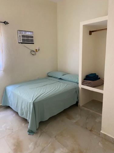 a small bedroom with a bed in a room at Los Amores Apartments A in Pérula