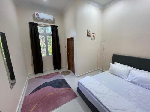 a small bedroom with a bed and a window at King's Cottage Homestay Kubang Kerian in Kota Bharu