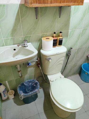 un bagno con un water e un lavandino di Puerto Galera Transient Kubo Guest Place a Puerto Galera