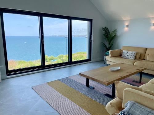 a living room with a view of the ocean at The Old Coastguard Lookout in Port Isaac