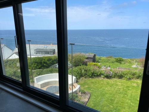 a window view of the ocean from a house at The Old Coastguard Lookout in Port Isaac