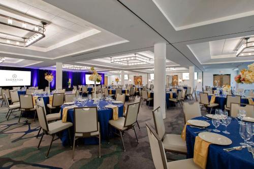 a banquet hall with blue tables and chairs at Sheraton Chapel Hill in Chapel Hill