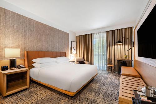 a hotel room with a bed and a television at Sheraton Chapel Hill in Chapel Hill