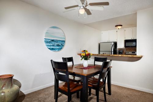 a kitchen and dining room with a table and chairs at Bargain Condo in Beach Resort A-206 in Oceanside
