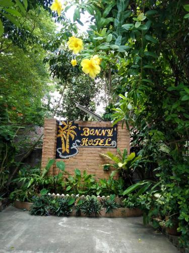 a sign for a zoo with yellow flowers at Bonny Hotel 4 Floors No Elevator in Lamai
