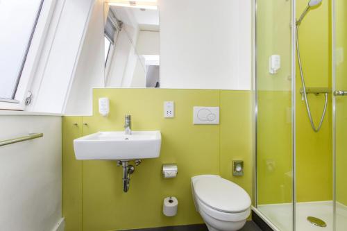 a bathroom with a sink and a toilet and a shower at mk hotel london in London