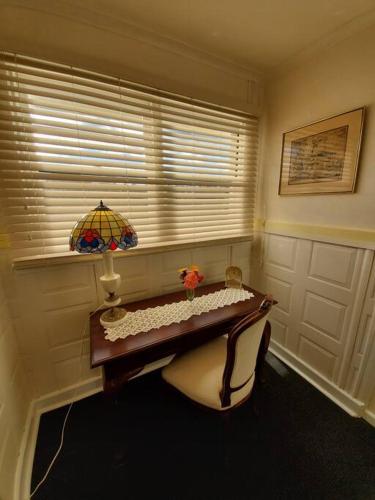 a room with a table and a bench and a window at Historic Apartment in Oatlands