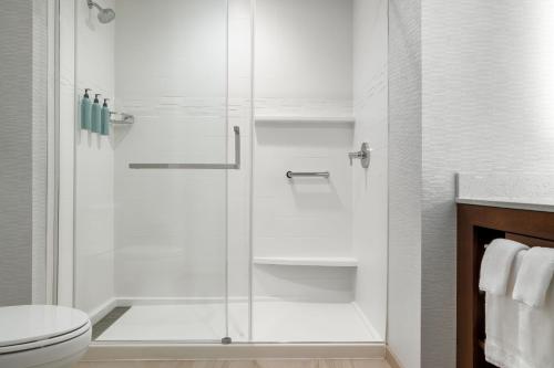 a bathroom with a shower and a toilet at Residence Inn Largo Medical Center Drive in Largo