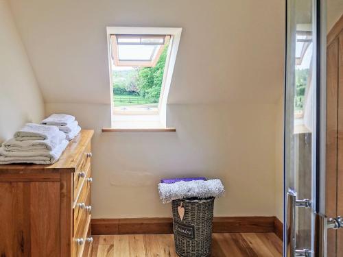 a bathroom with a counter with towels and a window at Green Acre Lodge in Tatterford