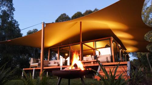 a tent with a fire in front of it at The Enchanted Retreat - Unforgettable Luxury Glamping in Havelock North