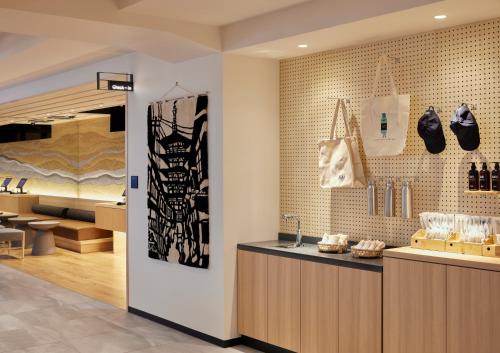 a store with a counter with shoes on the wall at ASAI Kyoto Shijo in Kyoto